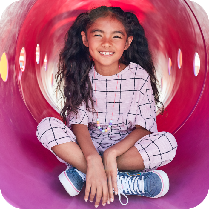 Girl sits on playground slide